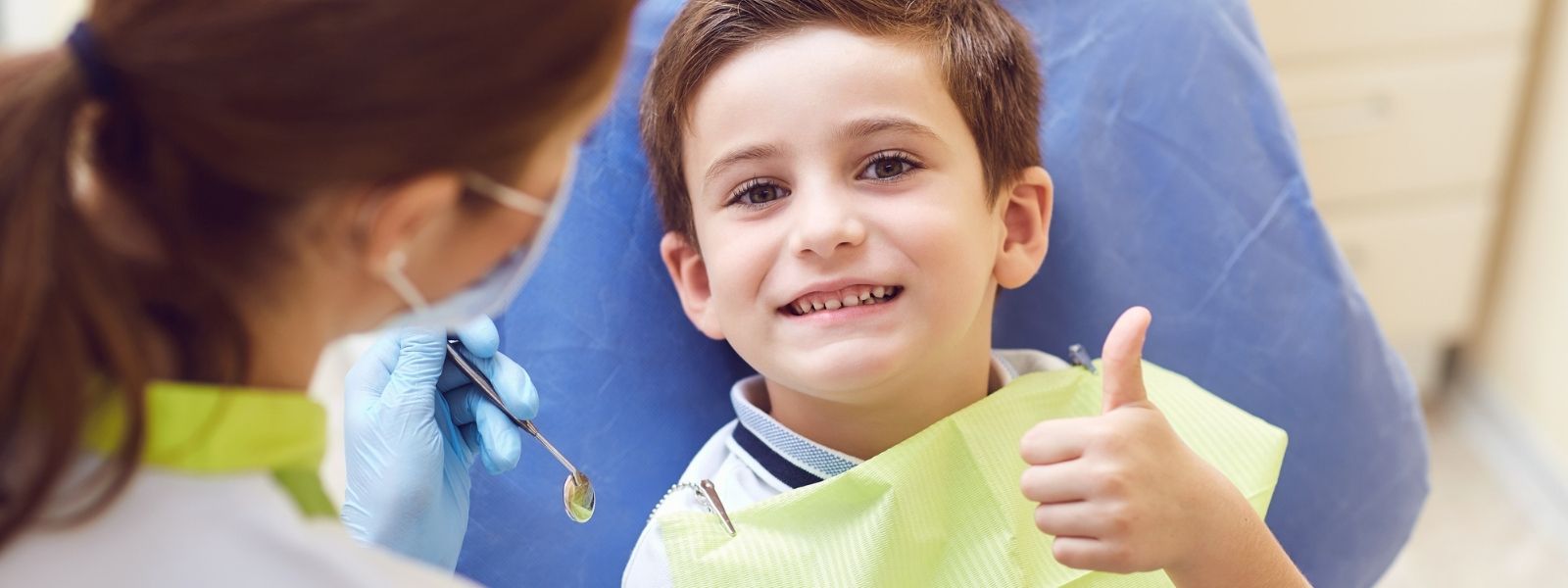 A kid showing a thumbs up