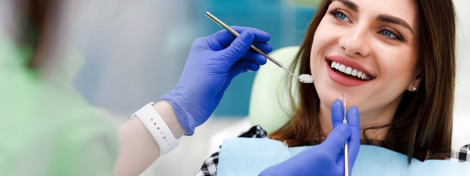 Pretty girl with brown hair having a dental check up