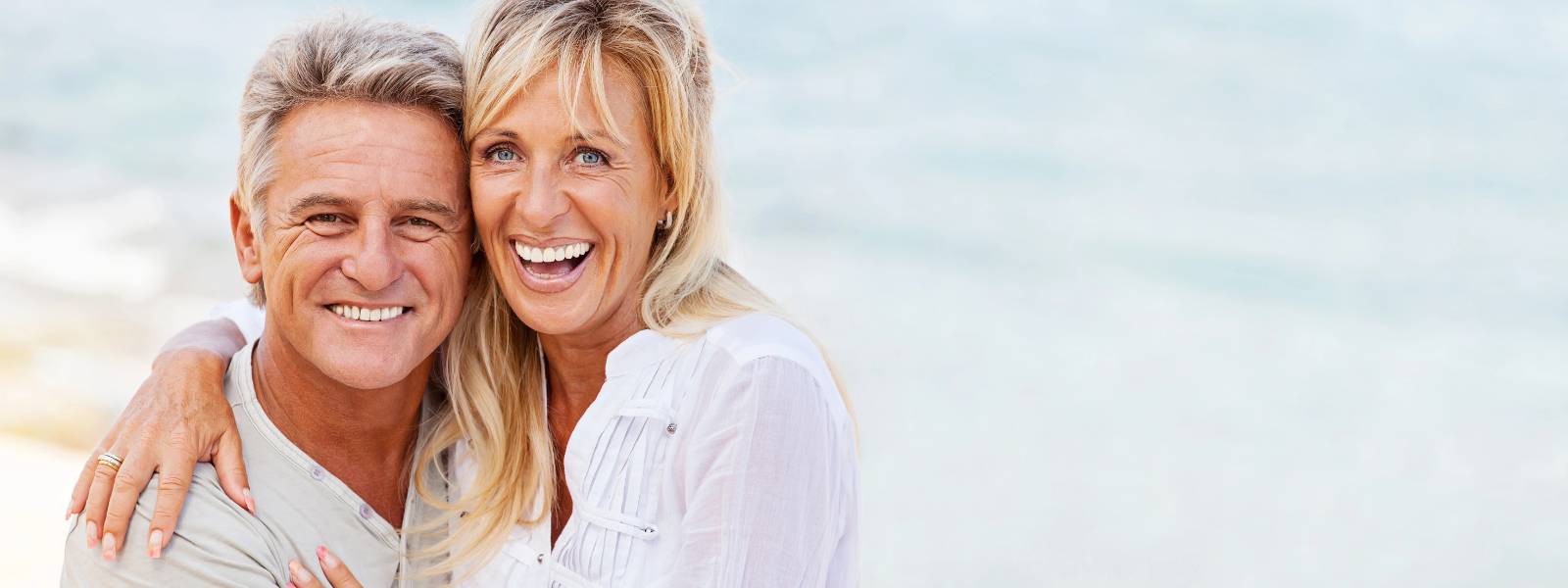 Happy elderly couple in beach