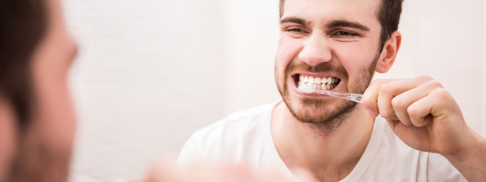 A brushing his teeth